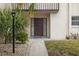 Condo entrance with walkway, landscaping, and exterior lighting at 311 Garvin St # 411B, Punta Gorda, FL 33950