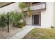 Condo entrance with walkway, landscaping, and exterior lighting at 311 Garvin St # 411B, Punta Gorda, FL 33950