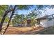 Home's backyard features a screened enclosure and a gravel ground cover at 3128 Ponce De Leon Blvd, North Port, FL 34291