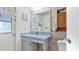 Bathroom with single sink vanity, shower/tub combo, and linen cabinet at 3128 Ponce De Leon Blvd, North Port, FL 34291