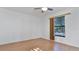 Simple bedroom with light wood floors and window with blinds at 3128 Ponce De Leon Blvd, North Port, FL 34291