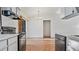 View of kitchen with black appliances and wood flooring at 3128 Ponce De Leon Blvd, North Port, FL 34291