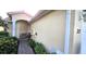 Tan stucco house with a paved walkway, landscaping, and small patio at 317 Monaco Dr # 7, Punta Gorda, FL 33950