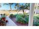 Brick walkway with lush landscaping leading to the front entrance at 317 Monaco Dr # 7, Punta Gorda, FL 33950