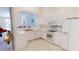 White kitchen with ample counter space and stainless steel appliances at 317 Monaco Dr # 7, Punta Gorda, FL 33950