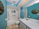 Updated bathroom with teal walls, a shower/tub combo, and modern vanity at 3341 Briant St, North Port, FL 34287