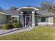 Inviting home exterior with a screened entryway and well-manicured lawn at 3341 Briant St, North Port, FL 34287