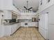 White kitchen with tile floors, ample counter space, and modern appliances at 3341 Briant St, North Port, FL 34287