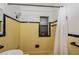 Clean bathroom with yellow tile and a shower/tub combo at 350 Duxbury Ave, Port Charlotte, FL 33952