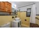 Bathroom with yellow tile, white vanity, and tub shower combo at 350 Duxbury Ave, Port Charlotte, FL 33952