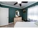 Cozy bedroom with teal walls, ceiling fan, and dresser at 350 Duxbury Ave, Port Charlotte, FL 33952