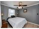 Bedroom with double bed, gray walls, and ceiling fan at 350 Duxbury Ave, Port Charlotte, FL 33952