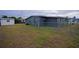 Dark gray house exterior with fenced backyard and shed at 350 Duxbury Ave, Port Charlotte, FL 33952