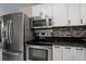 Stainless steel appliances and modern cabinetry in kitchen at 350 Duxbury Ave, Port Charlotte, FL 33952