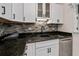 Modern kitchen with white cabinets, granite counters, and stainless steel appliances at 350 Duxbury Ave, Port Charlotte, FL 33952