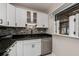 Modern white kitchen with granite countertops and stainless steel appliances at 350 Duxbury Ave, Port Charlotte, FL 33952