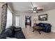 Living room with blue leather sofas, coffee table, and TV at 350 Duxbury Ave, Port Charlotte, FL 33952