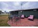 Brick patio with seating area and a metal table set at 350 Duxbury Ave, Port Charlotte, FL 33952