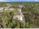 Home situated on a lot with surrounding trees and neighborhood view at 3953 Vehlin St, North Port, FL 34286