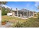 Screened patio with grassy yard and landscaping at 3953 Vehlin St, North Port, FL 34286