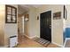 Bright entryway with a dark door and wood-look flooring at 3953 Vehlin St, North Port, FL 34286