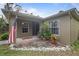 Inviting front porch with potted plants and flag at 3953 Vehlin St, North Port, FL 34286