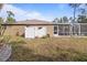 Home exterior view showcasing backyard and screened patio at 3953 Vehlin St, North Port, FL 34286