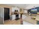 White cabinets, granite counters, and stainless steel appliances in this kitchen at 3953 Vehlin St, North Port, FL 34286