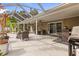 Screened patio with dining area and ceiling fans at 3953 Vehlin St, North Port, FL 34286