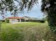 Large backyard with grassy area and patio at 4269 River Bank Way, Port Charlotte, FL 33980