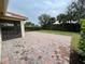 Backyard featuring brick patio and mature trees at 4269 River Bank Way, Port Charlotte, FL 33980