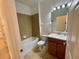 Clean bathroom with tub, toilet, and vanity with wood cabinets at 4269 River Bank Way, Port Charlotte, FL 33980