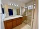 Modern bathroom with a large shower and a wood cabinet vanity at 4269 River Bank Way, Port Charlotte, FL 33980