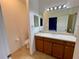 Clean bathroom with wood cabinets, a single sink vanity, and a shower at 4269 River Bank Way, Port Charlotte, FL 33980