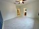 Bedroom featuring sleek marble-look flooring, neutral walls, and entryways to en-suite bathroom and closet at 4269 River Bank Way, Port Charlotte, FL 33980