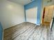 Bedroom featuring laminate floors, double door closet, and blue accent wall at 4269 River Bank Way, Port Charlotte, FL 33980