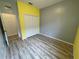 Bright bedroom with gray and yellow walls, and wood-look flooring at 4269 River Bank Way, Port Charlotte, FL 33980