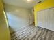 Bright bedroom featuring laminate floors, double door closet, and neutral color scheme at 4269 River Bank Way, Port Charlotte, FL 33980