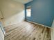 Bedroom with blue and beige walls, and wood-look flooring at 4269 River Bank Way, Port Charlotte, FL 33980