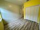 Bedroom with wood-look floors and yellow and beige walls at 4269 River Bank Way, Port Charlotte, FL 33980