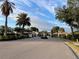 Gated entrance to a community with palm trees and landscaping at 4269 River Bank Way, Port Charlotte, FL 33980