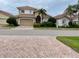 Two-story house with attached garage and manicured landscaping at 4269 River Bank Way, Port Charlotte, FL 33980