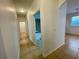 Hallway with tile floors and access to bedrooms and bathrooms at 4269 River Bank Way, Port Charlotte, FL 33980