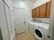 Laundry room with washer, dryer, and cabinets at 4269 River Bank Way, Port Charlotte, FL 33980