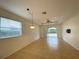 Bright living area with tile flooring, a tray ceiling with fan, and sliding doors leading to outdoor space at 4269 River Bank Way, Port Charlotte, FL 33980