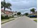 Neighborhood street featuring sidewalks, palm trees, and tile roofs at 4269 River Bank Way, Port Charlotte, FL 33980