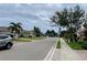 Neighborhood street featuring sidewalk and palm trees at 4269 River Bank Way, Port Charlotte, FL 33980