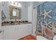 Bathroom with granite countertop, white cabinets, and starfish decor at 4297 Nettle Rd, Port Charlotte, FL 33953