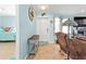 Inviting foyer with nautical decor, a wooden table, tiled floor, and a glimpse into the Primary bedroom at 4297 Nettle Rd, Port Charlotte, FL 33953