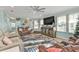 Comfortable living room featuring tile flooring, a ceiling fan, reclining sofas, and nautical-themed decor at 4297 Nettle Rd, Port Charlotte, FL 33953